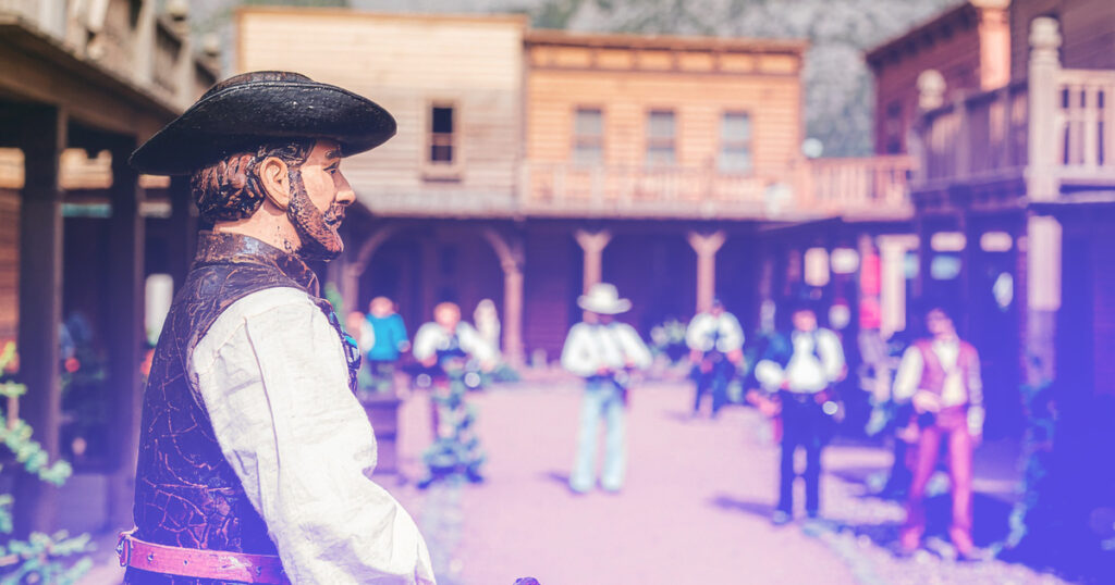 Wooden puppet cowboy in a toy wild west town